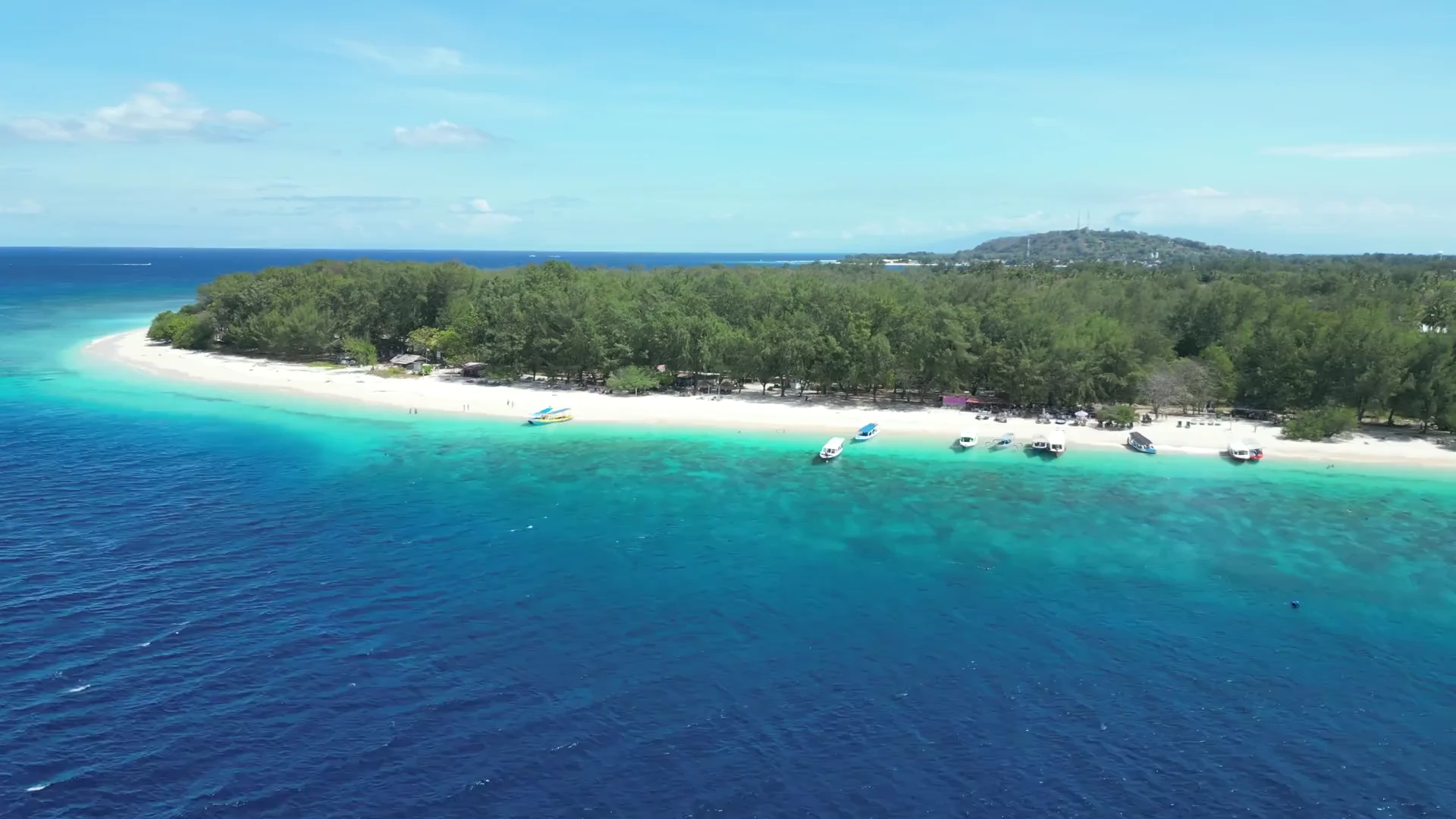 A turquoise coastline, opening a film of blue-water coast, seaside dining and water-activity holiday ideas.