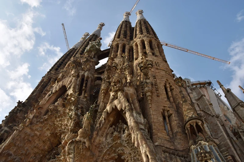 Sunlit Nativity façade and spires of Sagrada Família, Barcelona; architectural detail