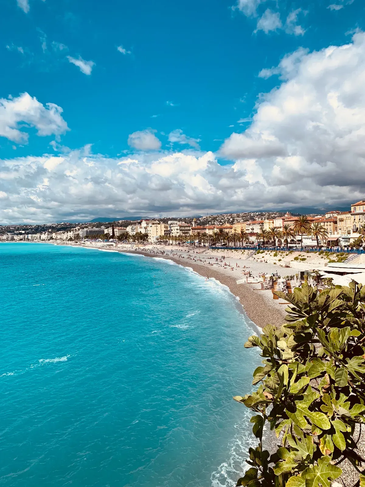 Turquoise Mediterranean water and the sweeping beachfront of Nice in sunshine