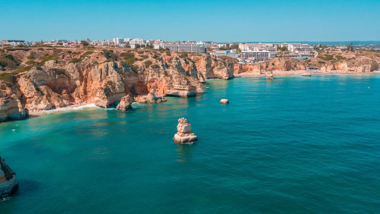 Golden cliffs and the blue Atlantic on the Algarve coast, Portugal.