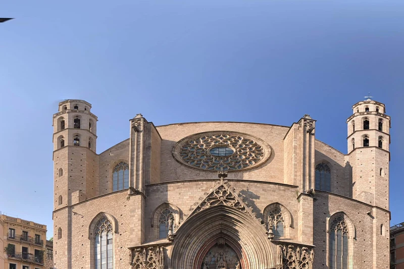 Sunlit upper façade, rose window and towers of Santa Maria del Mar, Barcelona